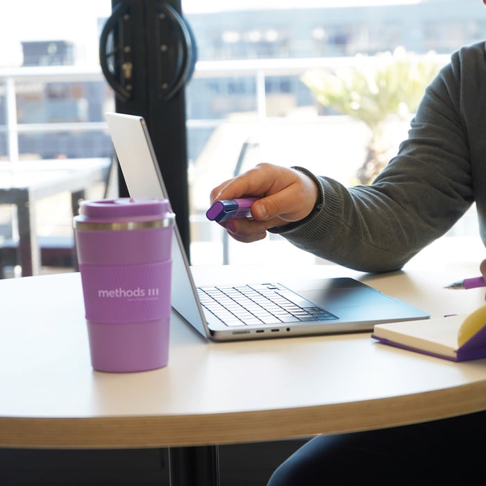 Decorative photo of a Methods employee working on a desk in the office
